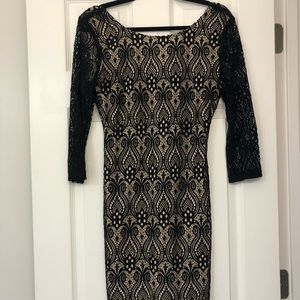 Sheer lace black dress with nude underlay.